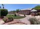 Well-manicured backyard with pool, outdoor kitchen, covered patio and landscape at 20769 N 106Th Ln, Peoria, AZ 85382