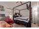 Comfortable bedroom features a four-poster bed, desk and chair, dresser, and modern fixtures at 20769 N 106Th Ln, Peoria, AZ 85382