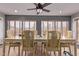 Bright dining room with large windows, tiled floors, and a ceiling fan, perfect for Gathering meals at 20769 N 106Th Ln, Peoria, AZ 85382
