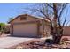 Exterior shot of a home showcasing a spacious two-car garage and desert landscaping at 20769 N 106Th Ln, Peoria, AZ 85382