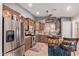 Well-lit kitchen with stainless steel appliances, granite countertops, and custom wood cabinetry at 20769 N 106Th Ln, Peoria, AZ 85382