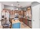 Bright kitchen featuring stainless steel appliances, granite countertops, custom wood cabinets and central island at 20769 N 106Th Ln, Peoria, AZ 85382