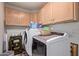 Functional laundry room with washer, dryer, and ample storage at 20769 N 106Th Ln, Peoria, AZ 85382