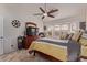 Bedroom featuring a bay window, dresser with TV, a ceiling fan and a cozy bed at 20769 N 106Th Ln, Peoria, AZ 85382