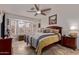 Comfortable primary bedroom with large bay window and ceiling fan with plenty of natural light at 20769 N 106Th Ln, Peoria, AZ 85382