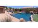 Inviting pool with surrounding patio, rock features and manicured landscape at 20769 N 106Th Ln, Peoria, AZ 85382
