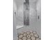 Elegant shower with marbled walls, decorative tile feature, seat and modern fixtures at 20769 N 106Th Ln, Peoria, AZ 85382