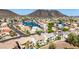 Aerial view of houses near a tranquil lake and mountain view at 21480 N 56Th Ave, Glendale, AZ 85308