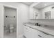 Modern bathroom with a sleek white vanity, marble countertop, and a matte black faucet at 21480 N 56Th Ave, Glendale, AZ 85308