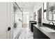 Stylish bathroom featuring double vanity, marble floors, and walk-in glass shower at 21480 N 56Th Ave, Glendale, AZ 85308