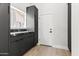 Well-organized laundry room with dark cabinetry, stone countertops, and ample storage space at 21480 N 56Th Ave, Glendale, AZ 85308