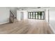 Large living room with hardwood floors and bi-fold doors to the backyard at 21480 N 56Th Ave, Glendale, AZ 85308