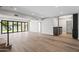 Open living room with hardwood floors, lake views and bi-fold doors at 21480 N 56Th Ave, Glendale, AZ 85308