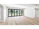 Bright living room with light wood floors and folding glass doors to the waterfront patio at 21480 N 56Th Ave, Glendale, AZ 85308