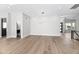 Open-concept living room with hardwood floors and contemporary light fixtures at 21480 N 56Th Ave, Glendale, AZ 85308
