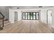 Bright living room featuring hardwood floors and lake views with bi-fold doors at 21480 N 56Th Ave, Glendale, AZ 85308