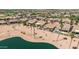 Expansive aerial view of a community featuring tile roofs, lakes, golf courses, and desert landscaping at 2163 N 164Th Dr, Goodyear, AZ 85395
