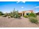 Lovely backyard featuring desert landscaping, including cactus and gravel, with a well-maintained stucco home at 2163 N 164Th Dr, Goodyear, AZ 85395