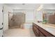 Bright bathroom featuring a double vanity, soaking tub, and separate tiled shower with seamless glass at 2163 N 164Th Dr, Goodyear, AZ 85395