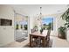 Bright dining room featuring a wooden table, sliding glass doors, and picturesque outdoor views at 2163 N 164Th Dr, Goodyear, AZ 85395