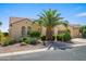 Attractive single-story home featuring a tile roof and low-maintenance desert landscaping with a palm tree at 2163 N 164Th Dr, Goodyear, AZ 85395