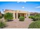 Back exterior view of home with covered patio and desert landscaping at 2163 N 164Th Dr, Goodyear, AZ 85395