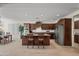 Spacious kitchen with dark wood cabinets, a large island, and stainless steel appliances, ideal for cooking at 2163 N 164Th Dr, Goodyear, AZ 85395