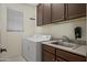 Functional laundry room with a sink, cabinets, and a washer/dryer at 2163 N 164Th Dr, Goodyear, AZ 85395