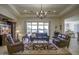 Spacious living room with large windows offering lake views and plush leather seating arrangement at 2163 N 164Th Dr, Goodyear, AZ 85395
