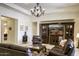 Inviting living room with dark leather furniture, a decorative chandelier, and a built-in media center at 2163 N 164Th Dr, Goodyear, AZ 85395