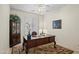 Functional home office with a classic wooden desk and a decorative china cabinet at 2163 N 164Th Dr, Goodyear, AZ 85395
