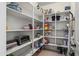 Organized walk-in pantry with ample shelving for storage, enhancing kitchen functionality and convenience at 2163 N 164Th Dr, Goodyear, AZ 85395