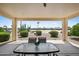 Covered patio with outdoor seating offering views of the community lake at 2163 N 164Th Dr, Goodyear, AZ 85395