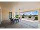 Covered patio with outdoor seating offering serene views of a landscaped backyard at 2163 N 164Th Dr, Goodyear, AZ 85395
