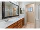 Primary bathroom featuring double sinks, updated mirror, and walk-in shower at 2541 N 86Th Ave, Phoenix, AZ 85037
