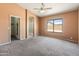 Spacious primary bedroom featuring an ensuite bathroom, walk-in closet, and neutral tones at 2541 N 86Th Ave, Phoenix, AZ 85037