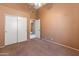 Empty bedroom with ceiling fan, carpeted floor, closet, and neutral-toned walls at 2541 N 86Th Ave, Phoenix, AZ 85037