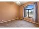 Bright empty bedroom with decorative window, carpet flooring and natural light at 2541 N 86Th Ave, Phoenix, AZ 85037
