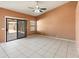 Inviting bedroom with tile flooring, sliding glass door, and natural light at 2541 N 86Th Ave, Phoenix, AZ 85037