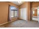Empty bedroom featuring a ceiling fan, a view outside and an entrance to another room at 2541 N 86Th Ave, Phoenix, AZ 85037