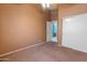 Empty bedroom with closet, doorway to bath, carpet and neutral-colored walls at 2541 N 86Th Ave, Phoenix, AZ 85037