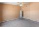Bedroom featuring neutral carpeting, a ceiling fan, and a large closet at 2541 N 86Th Ave, Phoenix, AZ 85037