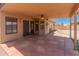 Relaxing covered patio with ceiling fan overlooking the spacious backyard at 2541 N 86Th Ave, Phoenix, AZ 85037