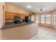 Functional kitchen with breakfast bar, tile floors, and modern appliances at 2541 N 86Th Ave, Phoenix, AZ 85037