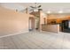 Open living room area with adjacent kitchen and neutral color scheme at 2541 N 86Th Ave, Phoenix, AZ 85037