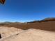 New home backyard with block fence, mountain views, and dirt for landscaping at 27358 N 69Th Dr, Peoria, AZ 85383