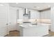 Modern kitchen features white cabinetry, quartz countertops, and stainless steel appliances at 27358 N 69Th Dr, Peoria, AZ 85383