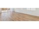 Bright living room with wood-look tile flooring and sliding glass doors at 27358 N 69Th Dr, Peoria, AZ 85383