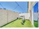 Enclosed backyard with artificial turf, workout bench, and neutral paint on the walls at 3034 N 39Th St # 12, Phoenix, AZ 85018
