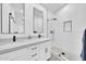 A bright bathroom with dual sinks, sleek faucets, and a glass-enclosed shower with a niche at 3034 N 39Th St # 12, Phoenix, AZ 85018